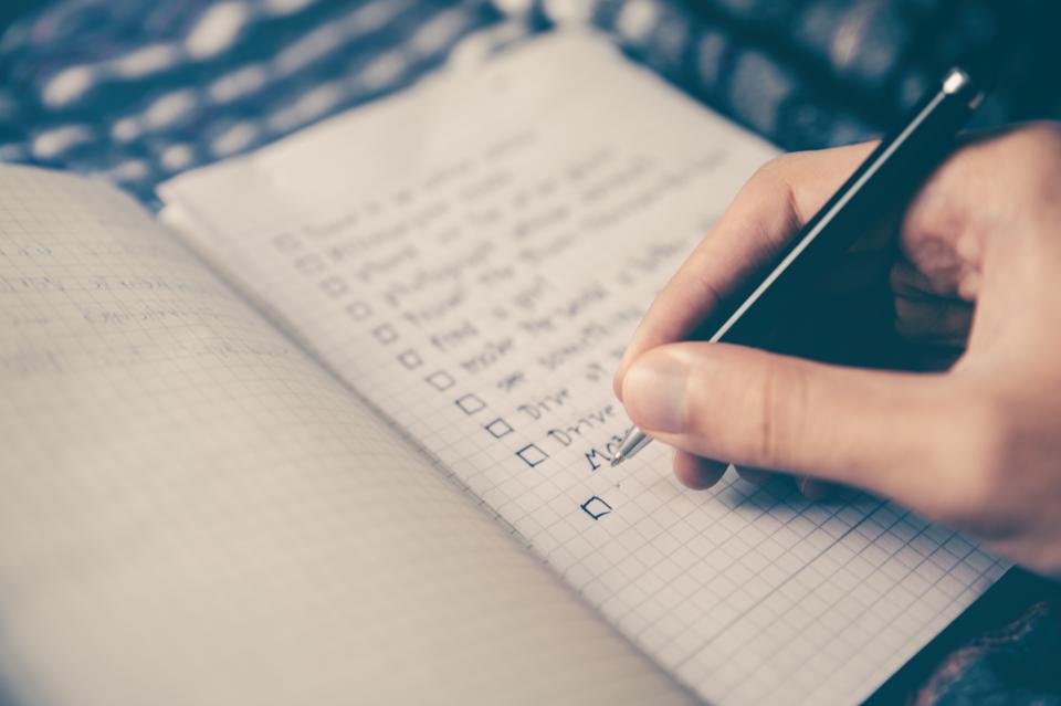 A handwritten checklist on paper, representing the checklist used to evaluate an SEO proposal.